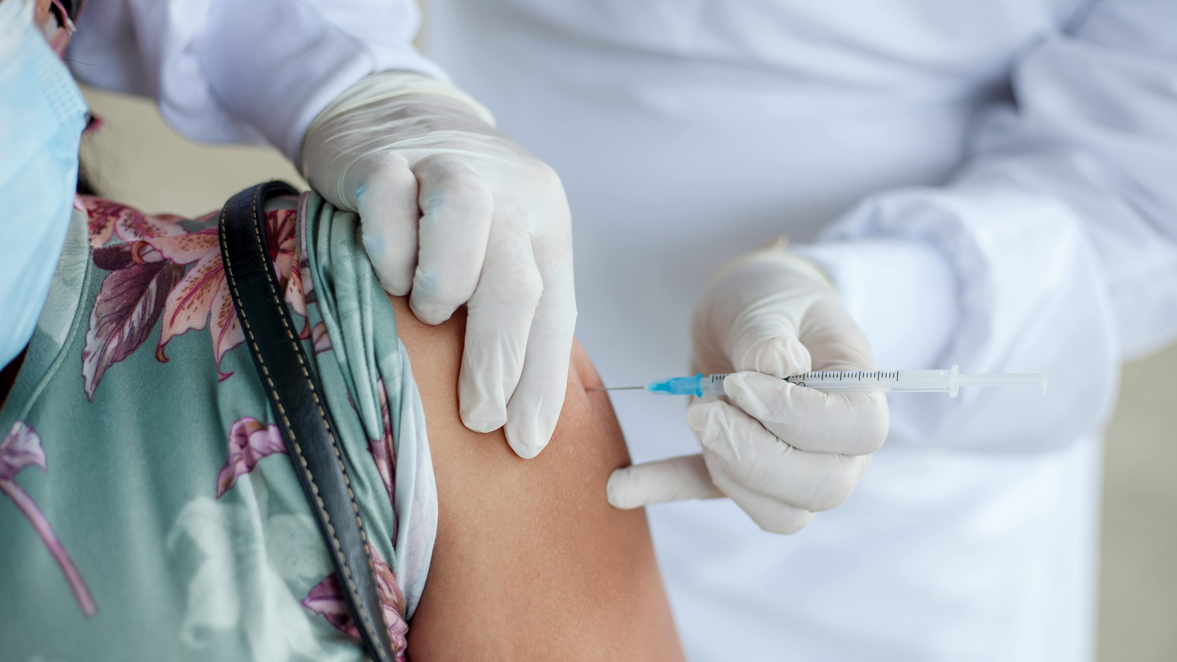 Pessoa tomando vacina no braço