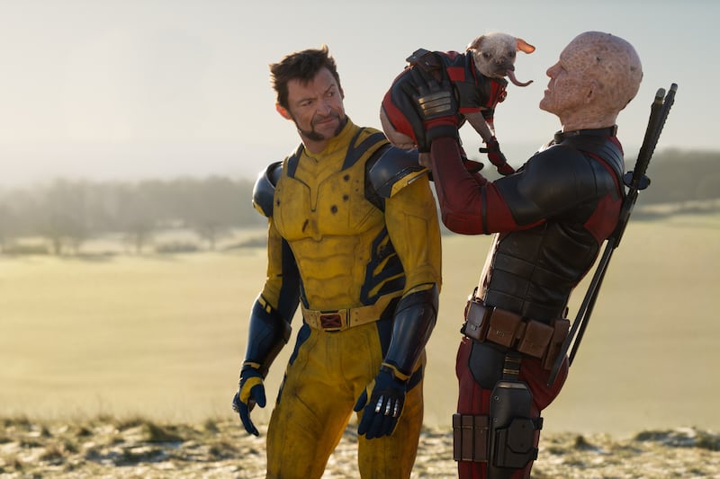 (L-R): Hugh Jackman as Wolverine/Logan, Dogpool, and Ryan Reynolds as Deadpool/Wade Wilson in 20th Century Studios/Marvel Studios' DEADPOOL & WOLVERINE. Photo by Jay Maidment. © 2024 20th Century Studios / © and ™ 2024 MARVEL.